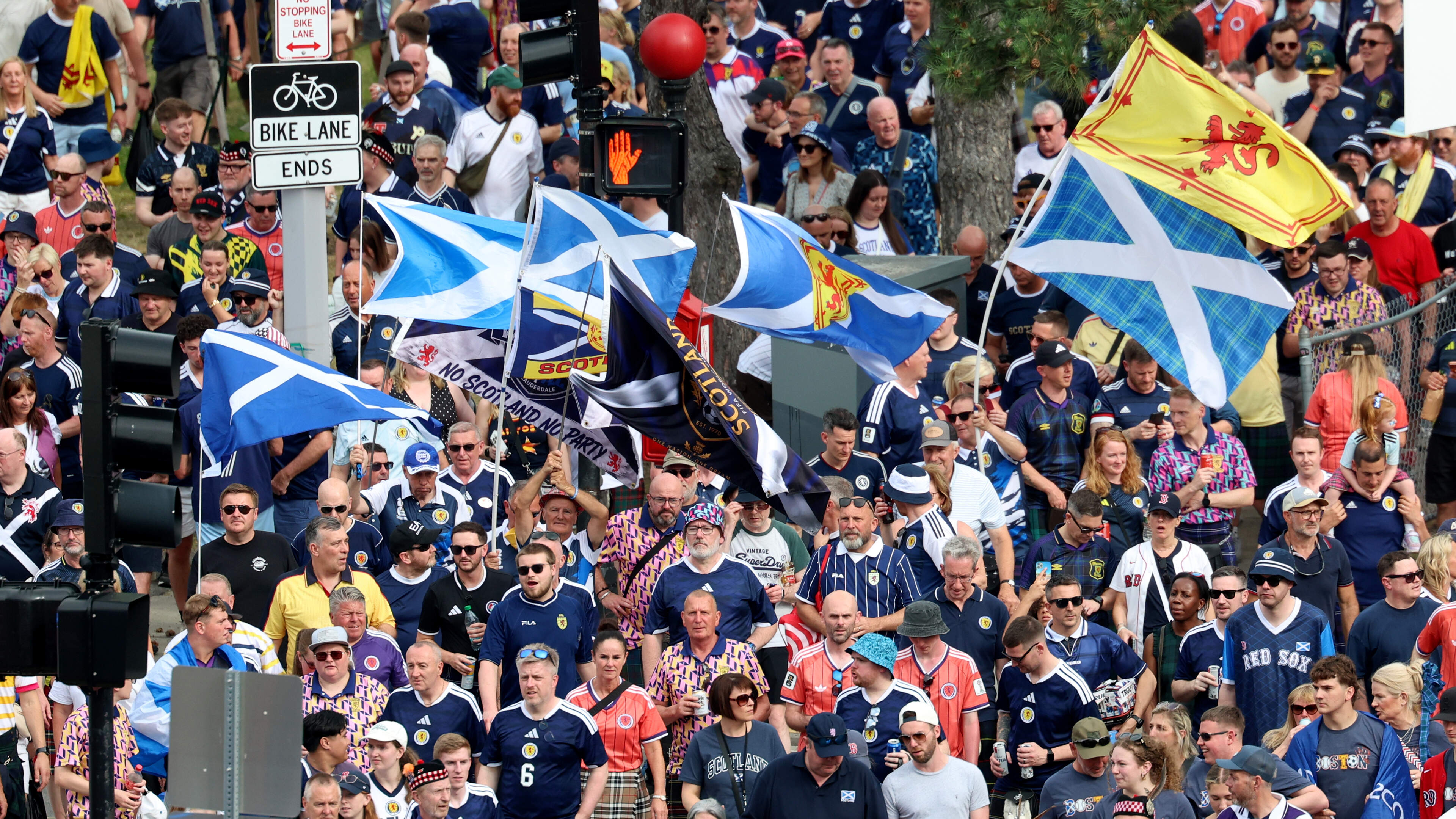 Four men in orange sing themselves hoarse in a pub full of hospitable Scottish football fans