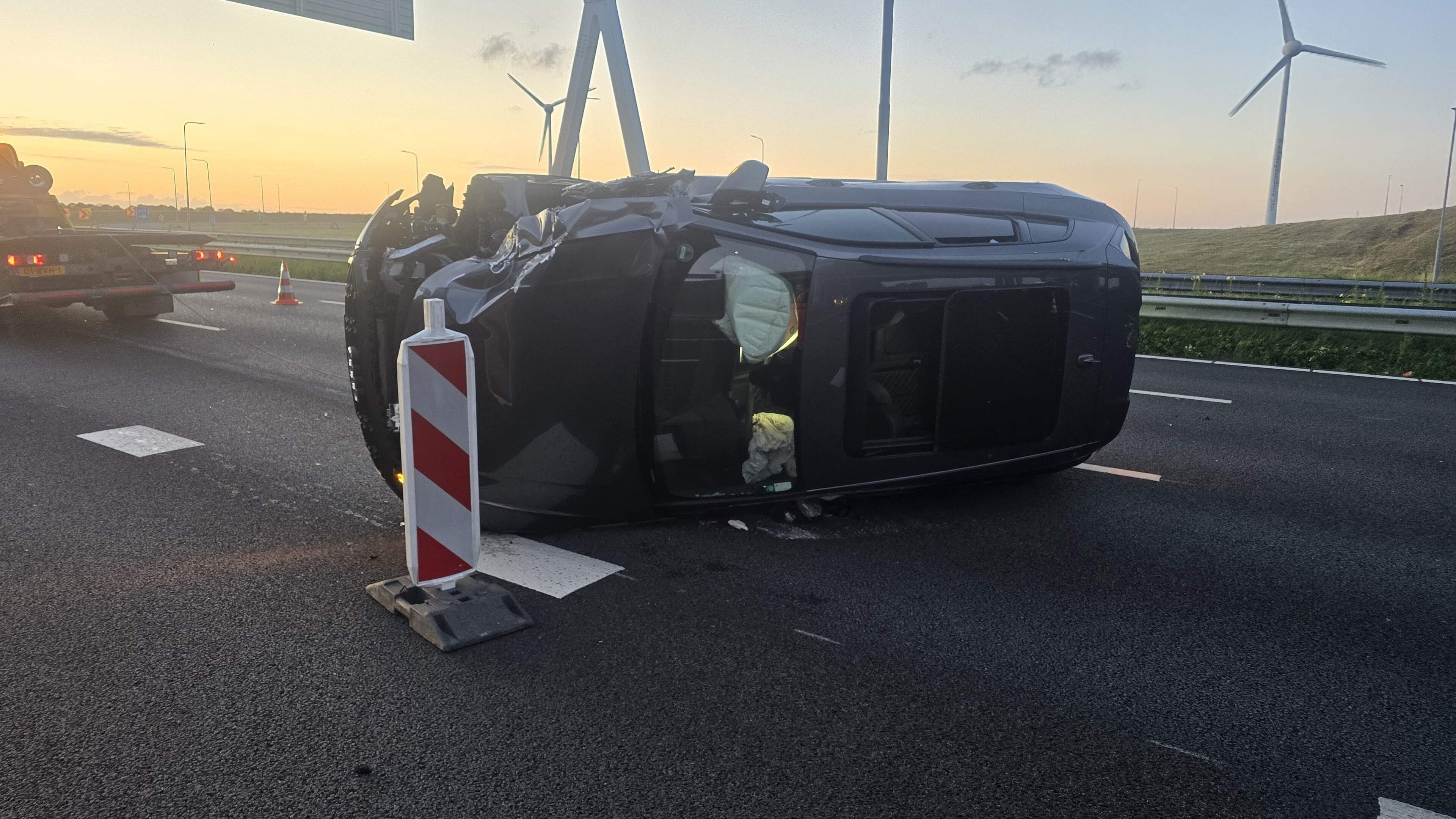 Car crashes into highway arrow truck and flips onto side on A4 near Nieuw-Vennep