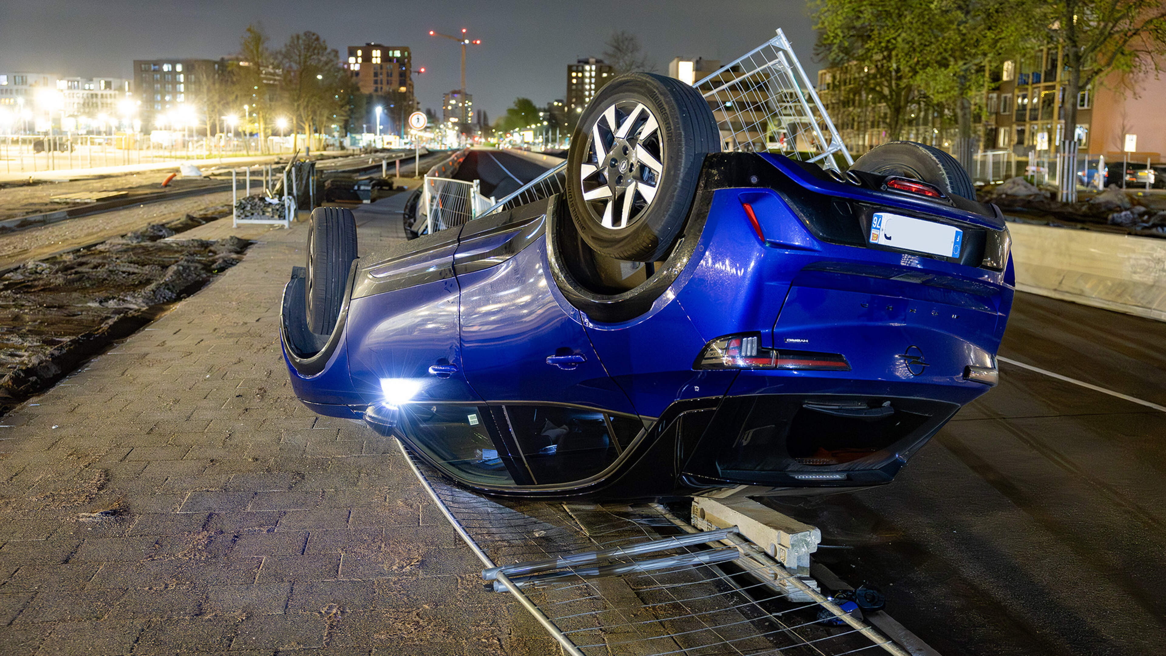 Car with French license plate flips over on bus lane in Haarlem