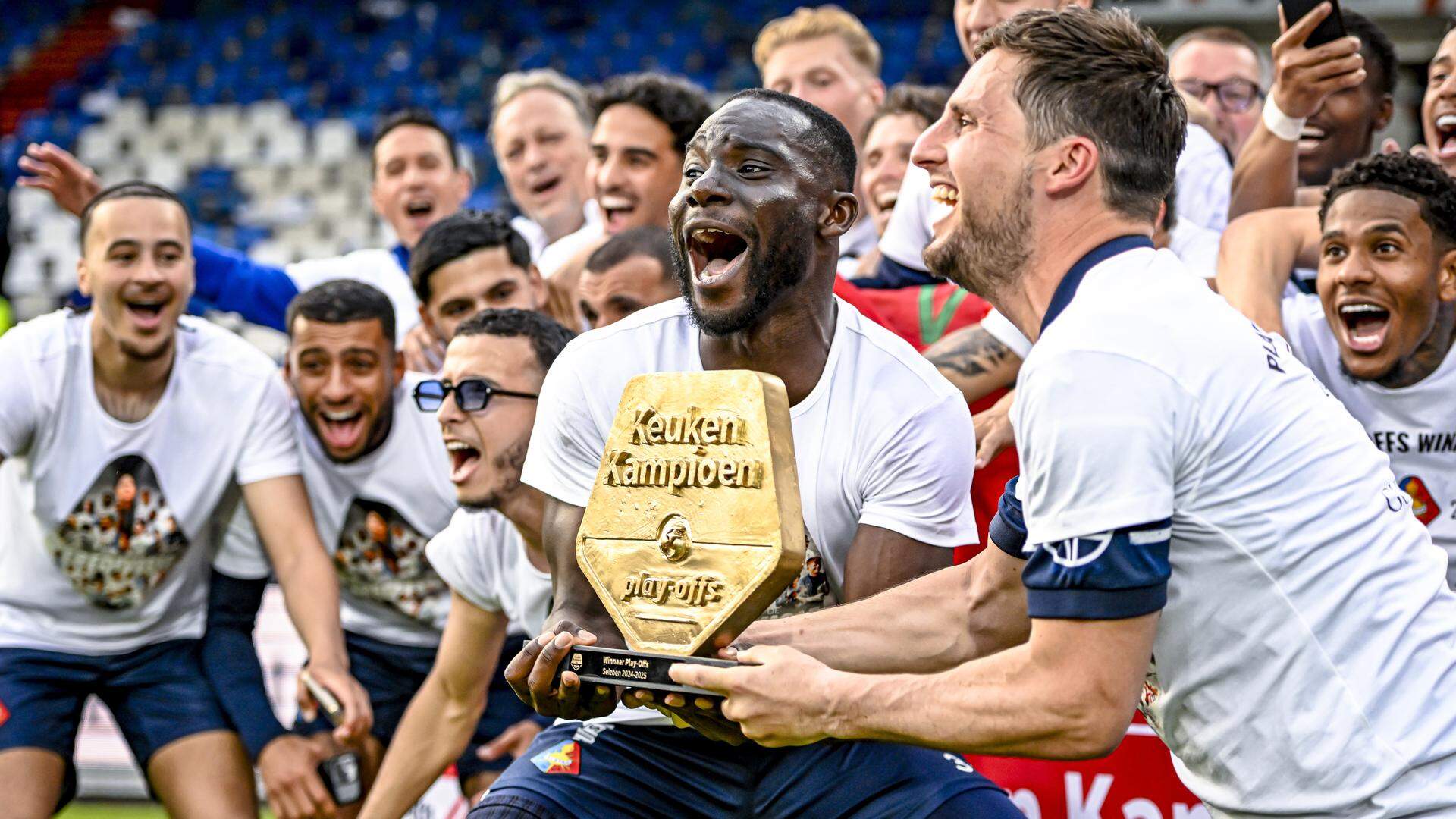 Mitch Apau met het schild dat hoort bij de winst in de play-offs.