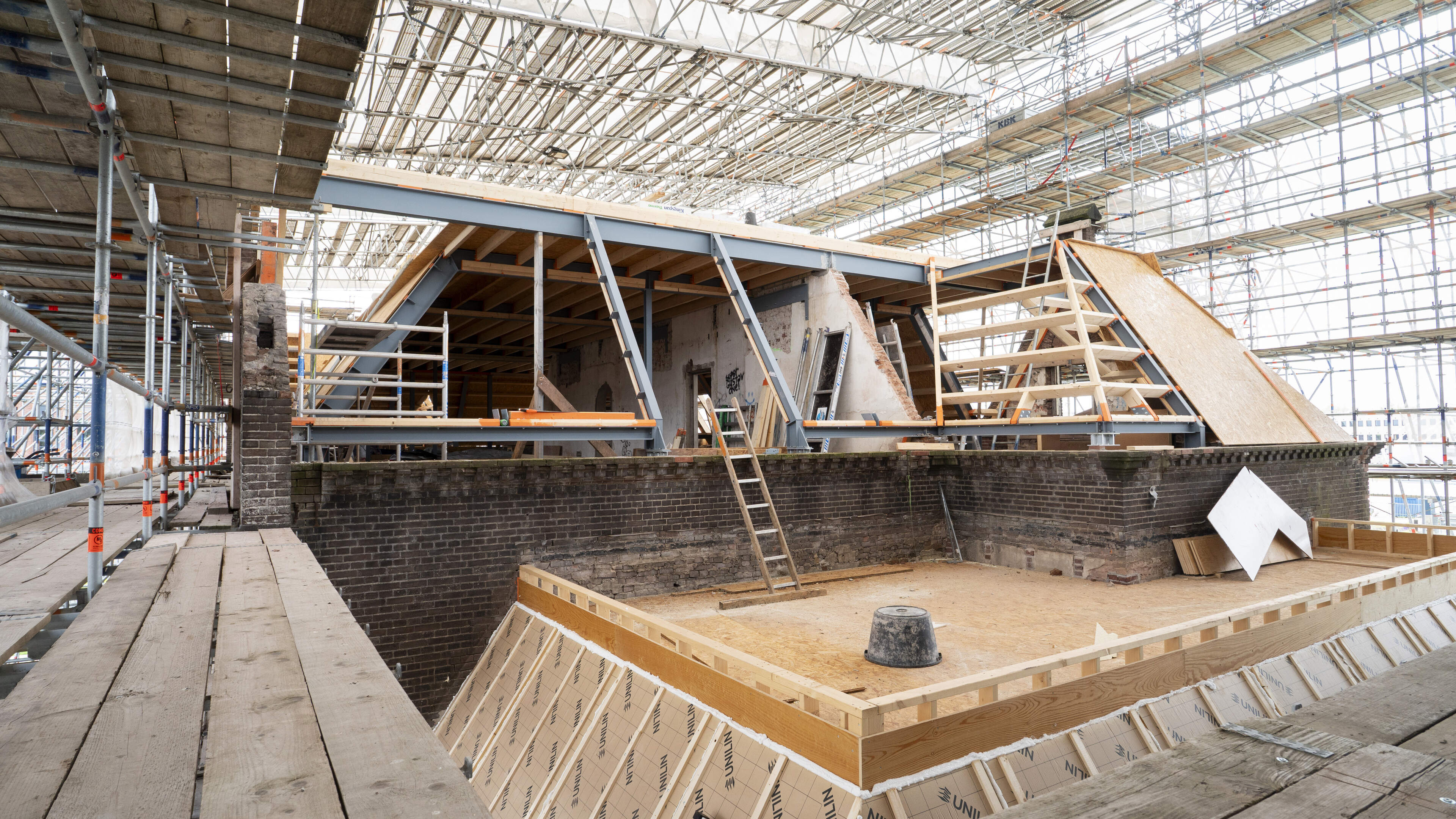 Wandering among the imposing scaffolding of a monumental ruin: 'Look, the century-old neighbor in East is rising again'