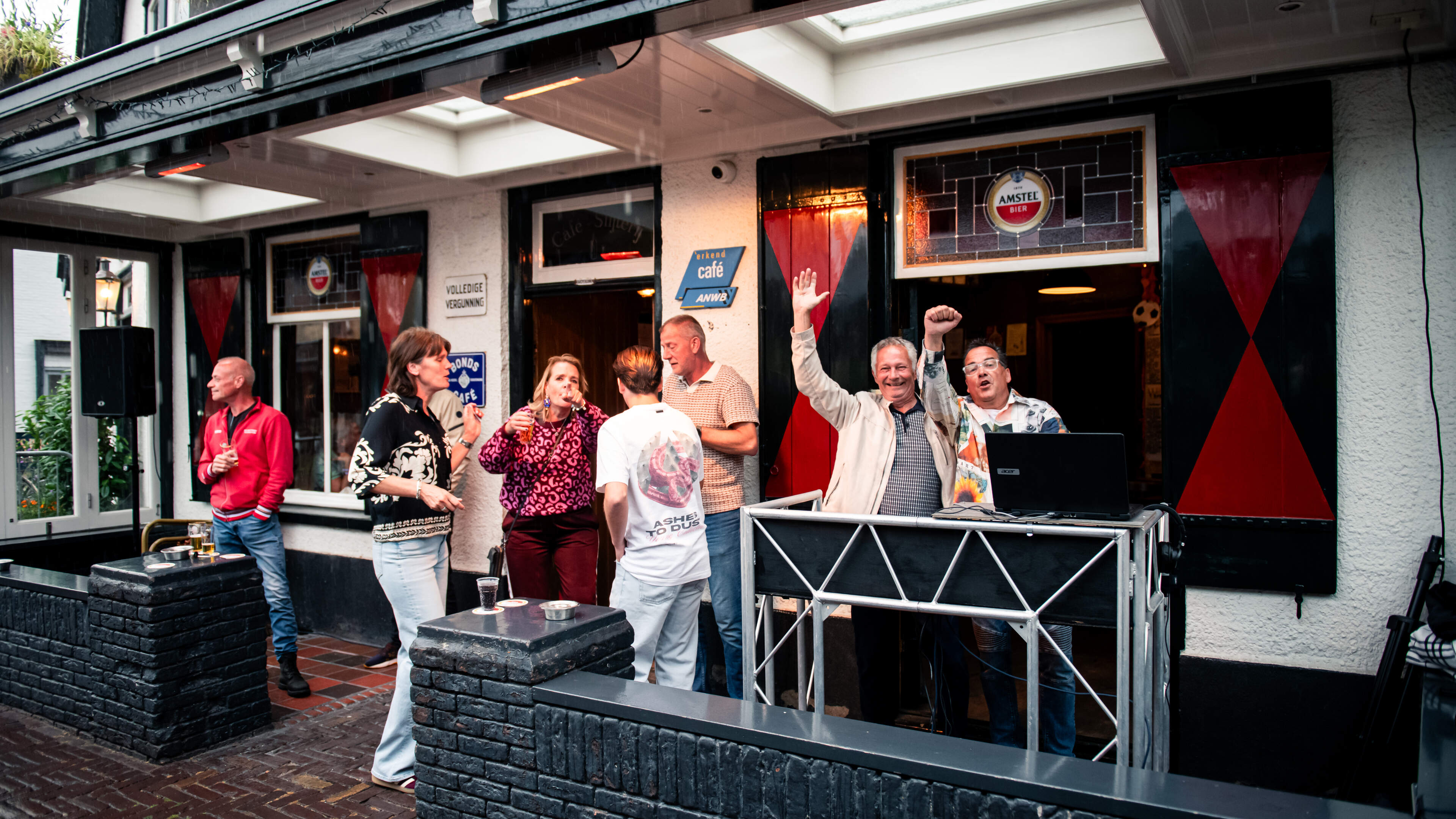 Visitors fill the square at Café Bartje until late during Santpoort Square Party
