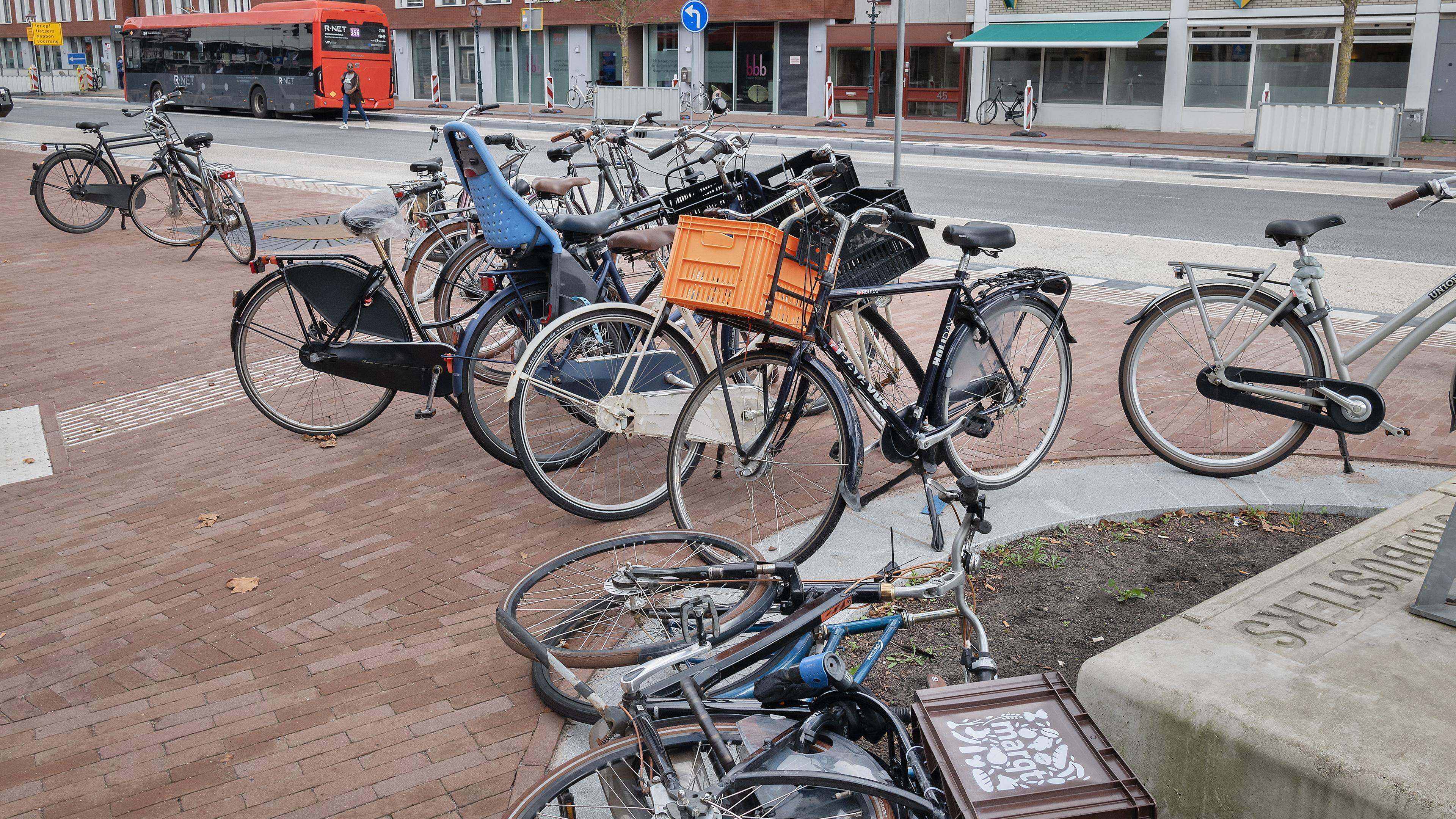 Boa’s gaan foutgeparkeerde fietsen bij het Houtplein afvoeren. ’De overlast neemt nu niet af’